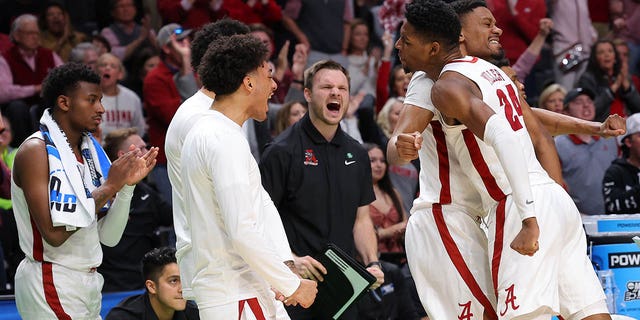 Brandon Miller #24 of the Alabama Crimson Tide celebrates with teammates during the first half against the Maryland Terrapins in the second round of the NCAA Men's Basketball Tournament at Legacy Arena at the BJCC on March 18, 2023, in Birmingham, Alabama. 