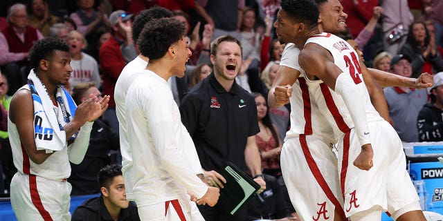 Brandon Miller #24 of the Alabama Crimson Tide celebrates with teammates during the first half against the Maryland Terrapins in the second round of the NCAA Men's Basketball Tournament at Legacy Arena at the BJCC on March 18, 2023, in Birmingham, Alabama.