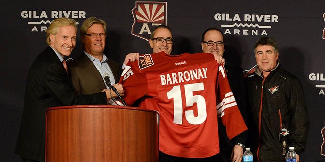 Left to right: Executive Vice President Don Maloney; Co-owner and Director Craig Stewart; Owner, Chairman and Governor Andrew Barroway; President and CEO Antoney LeBlanc; and head coach Dave Tippett of the Arizona Coyotes pose for a photo during a press conference prior to a game against the Columbus Blue Jackets at Gila River Arena Jan. 3, 2015, in Glendale, Ariz.
