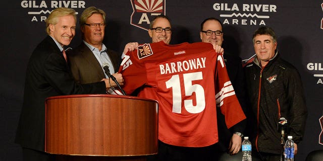 From left to right: Executive Vice President Don Maloney;  co-owner and director Craig Stewart;  owner, president and governor Andrew Barroway;  Chairman and CEO Antoney LeBlanc;  and Arizona Coyotes head coach Dave Tippett pose for a photo during a news conference before a game against the Columbus Blue Jackets at Gila River Arena on January 3, 2015 in Glendale, Arizona.