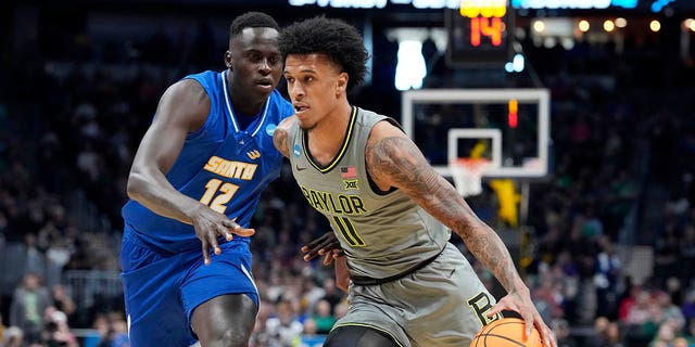 Baylor forward Jalen Bridges, front, drives past UC Santa Barbara forward Evans Kipruto in the first half of a first-round college basketball game in the men's NCAA Tournament, Friday, March 17, 2023, in Denver. 