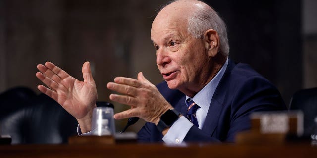 Sen. Ben Cardin raises hands during hearing