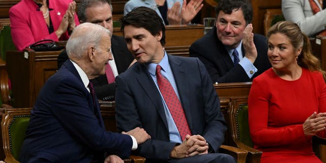 US President Joe Biden speaks with Canadian Prime Minister Justin Trudeau following his address to the Canadian Parliament in Ottawa, Ontario, Canada, on March 24, 2023. 