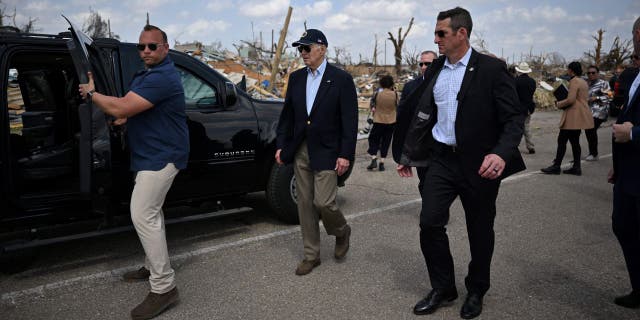 US President Joe Biden walks to his car successful Rolling Fork, Mississippi, connected March 31, 2023 aft touring a heavy damaged neighborhood.