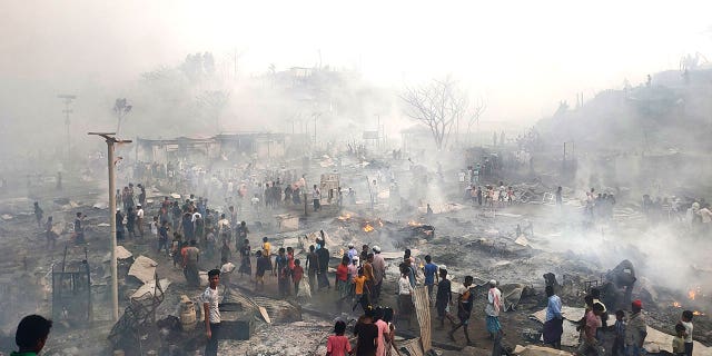 Rohingya refugees look for their belongings after a major fire broke in Balukhali camp in Bangladesh, on March 5, 2023. 