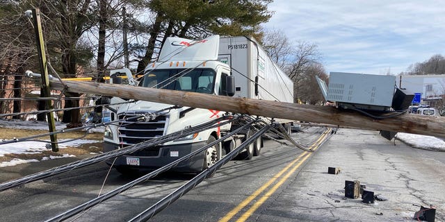 A driver was trapped under downed power lines in Stoneham, Massachusetts.