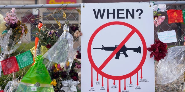 On April 9, 2021, in Boulder, Colorado, tributes hang on the temporary fence surrounding the parking lot in front of a King Soopers grocery store, where 10 people died in a late March 2021 mass shooting. The son of one of 10 people killed at the Colorado supermarket in 2021 filed a lawsuit Tuesday, March 14, 2023, against gun maker Sturm, Ruger & Co. over how it marketed the firearm used in the massacre.