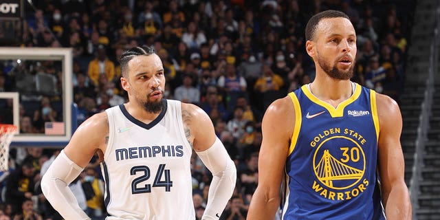 Dillon Brooks, #24 of the Memphis Grizzlies, and Stephen Curry, #30 of the Golden State Warriors, look on during Game 6 of the 2022 NBA Playoffs Western Conference Semifinals on May 13, 2021 at the Chase Center in San Francisco, California. 