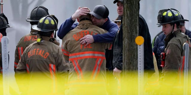 Buffalo, New York, firefighters console each different pursuing confirmation that a workfellow died wrong a burning commercialized building.