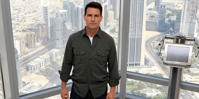 Tom Cruise standing inside the Burj Khalifa at a press conference for Mission Impossible