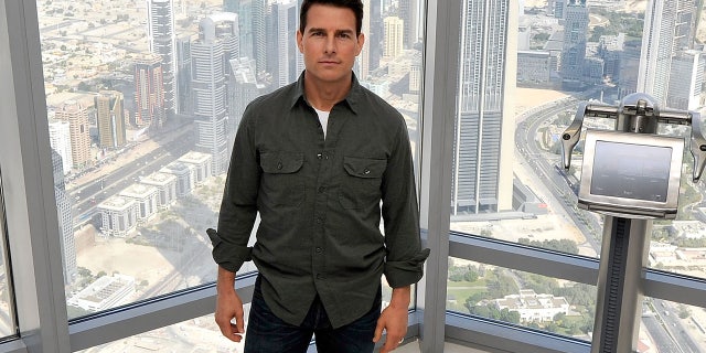 Tom Cruise standing inside the Burj Khalifa at a press conference for Mission Impossible