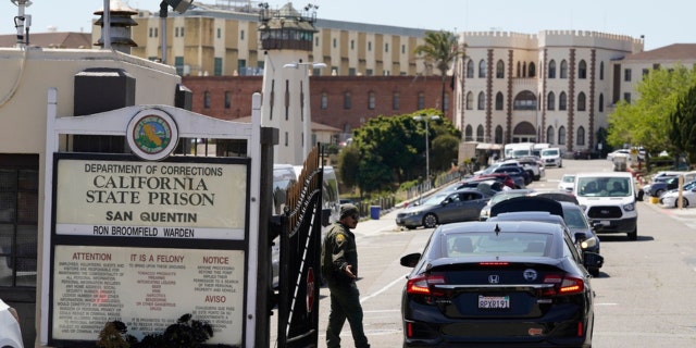 A guard checks vehicles entering the main gate at San Quentin State Prison on April 12, 2022, in San Quentin, California.