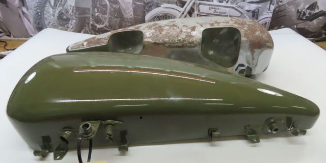Among the parts being auctioned are original gas tanks for vintage bikes.