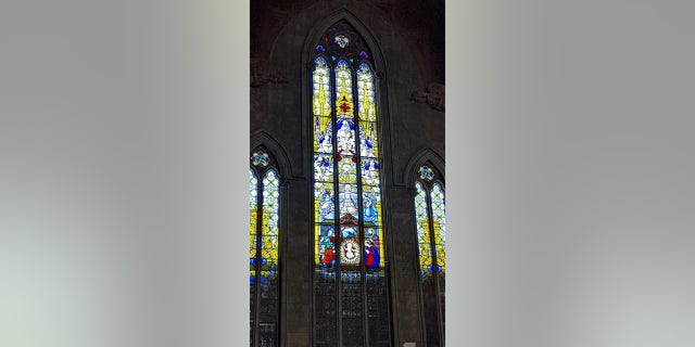 Stained-glass windows appear throughout the church.