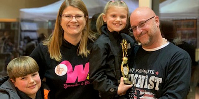 Crystal and Brian Clark, shown with their two kids, Xander (bottom left) and Ziva (middle), are spreading awareness about the importance of getting trees checked after the children's unexpected deaths at a campground in Indiana on April 23, 2022.