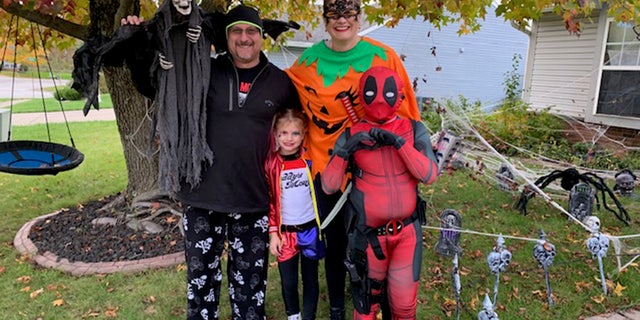 Crystal and Brian Clark are seen in Halloween costumes with their late children, Ziva (front left) and Xander (front right).
