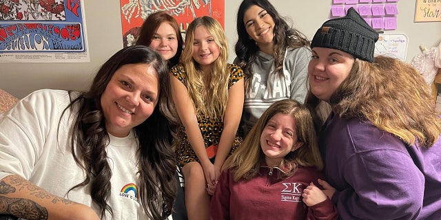 Tiffany Eckert (left) hangs out at the Kappa Sigma house with a variety of family members and friends.