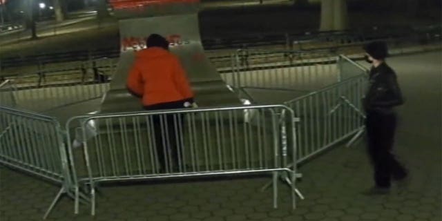 NYPD video shows alleged vandals spray-painting a statue of Christopher Columbus in Central Park last month.