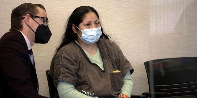 Yesenia Guadalupe Ramirez, center, 1 of 2 suspects charged successful relationship pinch nan kidnapping of a 3-month-old baby, appears for her arraignment proceeding connected April 28, 2022.