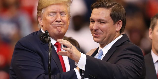 Then-President Donald Trump, left, introduces Florida Gov.  Ron DeSantis during a campaign rally, Nov. 26, 2019, in Sunrise, Florida.