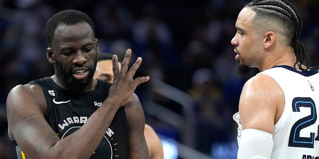 Draymond Green, #23 of the Golden State Warriors, and Dillon Brooks, #24 of the Memphis Grizzlies, exchange words with each other during the second quarter at the Chase Center on December 25, 2022, in San Francisco, California. 