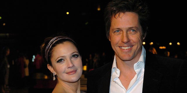 Drew Barrymore, left, and Hugh Grant pose at the "Music and Lyrics" premiere in 2007.