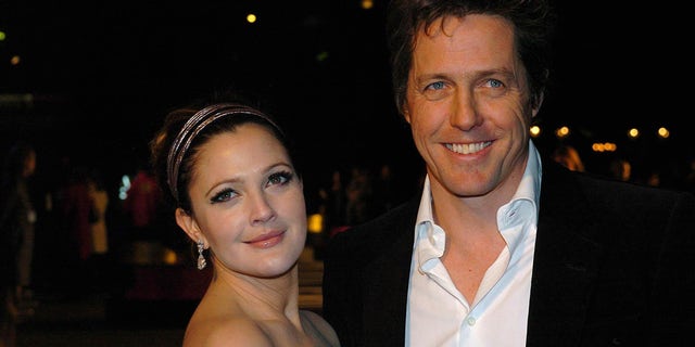 Drew Barrymore, left, and Hugh Grant pose at the "Music and Lyrics" premiere in 2007.