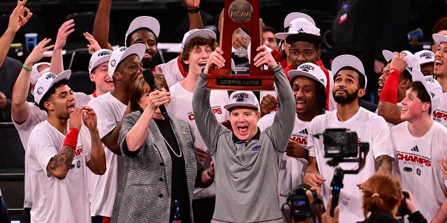 Florida Atlantic Owls head coach Dusty May holds the Eastern Regional Championship trophy after defeating the Kansas State Wildcats in the game during the Elite Eight round of the 2023 NCAA Men's Basketball Tournament held at Madison Square Garden on March 25, 2023 in New York City.
