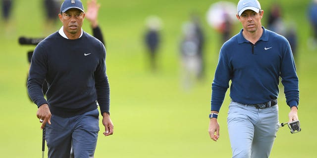 Tiger Woods and Rory McIlroy walk to the 18th green during the first round of the Genesis Invitational Feb. 16, 2023, at Riviera Country Club in Pacific Palisades, Calif.