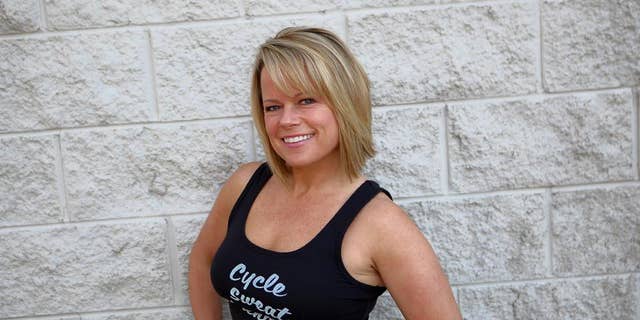 Erin Gratsch still teaches spin classes at Power Ryde, a local indoor cycling studio. She is pictured here in 2016, shortly before her first breast cancer diagnosis. 