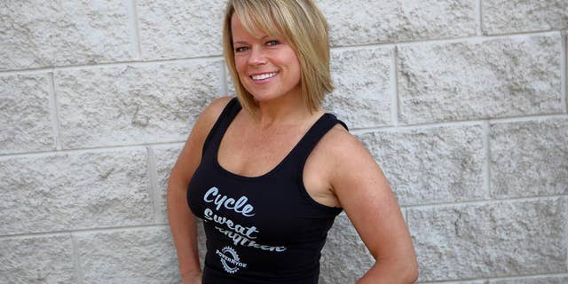 Erin Gratsch still teaches spin classes at Power Ryde, a local indoor cycling studio. She is pictured here in 2016, shortly before her first breast cancer diagnosis. 