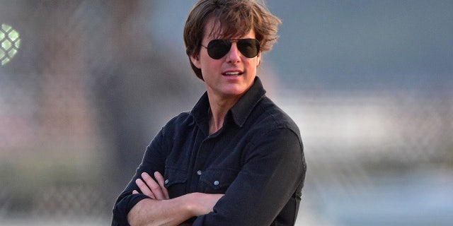 Tom Cruise on the helipad getting ready to board a helicopter