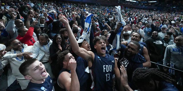 Jo'el Emanuel, #13 of the Fairleigh Dickinson Knights, celebrates with the crowd after beating the Purdue Boilermakers 63-58 in the first round of the NCAA Men's Basketball Tournament at Nationwide Arena on March 17, 2023, in Columbus, Ohio.