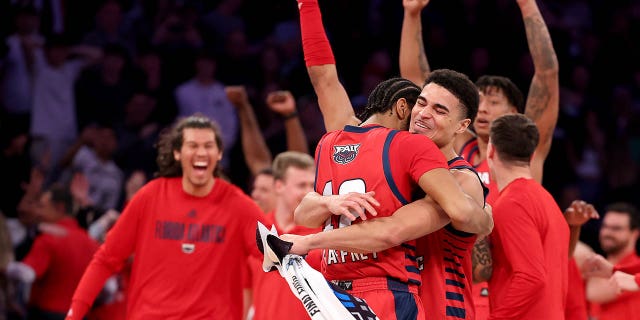 Jalen Gaffney (12) and Bryan Greenlee (4) of the Florida Atlantic Owls celebrate after defeating the Kansas State Wildcats in the Elite Eight of the NCAA Tournament at Madison Square Garden March 25, 2023, in New York City.