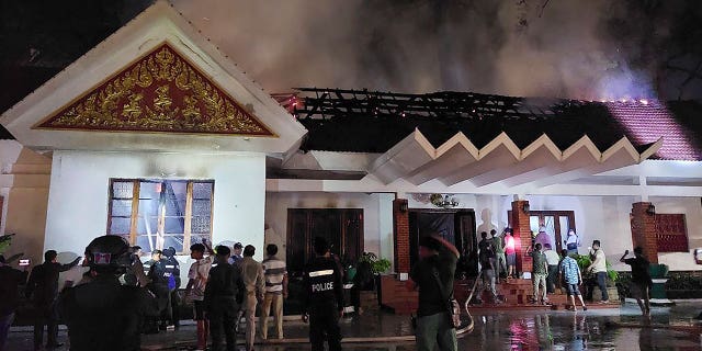 Local authorities try to put out a fire at Cambodia King Norodom Sihamoni’s royal residence in Siem Reap on March 12, 2023.