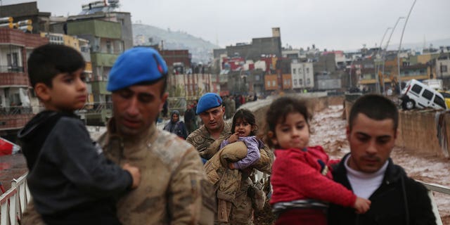 People are being rescued after heavy rains flooded the area in Sanliurfa, Turkey, on March 15, 2023. 