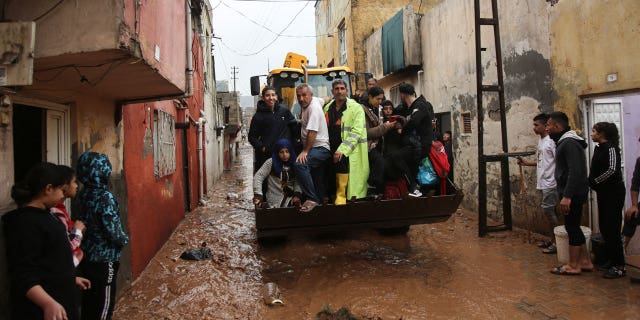 People are rescued during floods after heavy rains in Sanliurfa, Turkey, on March 15, 2023. 