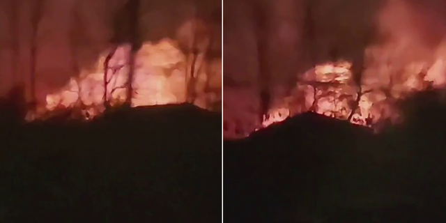 In this screen grab taken from video, a driver captures flames shooting up from a building during a structure fire in Flushing, Michigan.