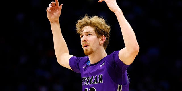 ORLANDO, FLORIDA - MARCH 16: Garrett Hien #13 of the Furman Paladins reacts against the Virginia Cavaliers during the second half of the first round of the NCAA Men's Basketball Tournament at the Amway Center on March 16, 2023 in Orlando, Florida. 