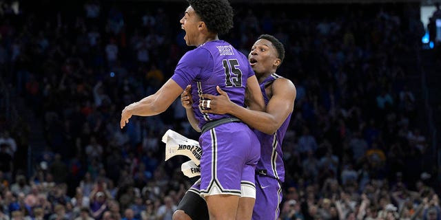 Furman forward Tyrese Hughey (15) and forward Alex Williams celebrate their victory against Virginia during a first-round game at the NCAA tournament on Thursday, March 16, 2023, in Orlando, Florida. 