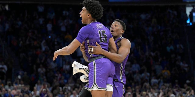 Furman forward Tyrese Hughey (15) and forward Alex Williams celebrate their victory against Virginia during a first-round game at the NCAA tournament on Thursday, March 16, 2023, in Orlando, Florida. 