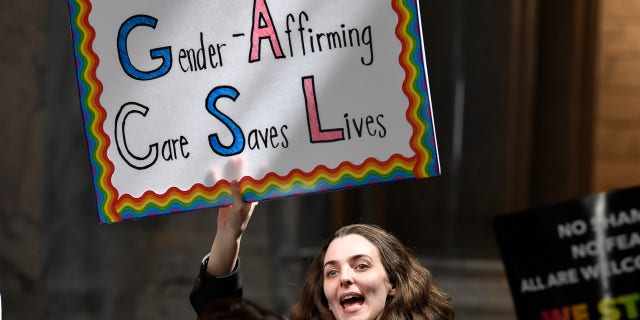 A protester shows her opposition to Kentucky Senate bill SB150, known as the Transgender Health Bill outside the Senate chamber at the Kentucky State Capitol in Frankfort, Ky., Wednesday, March 29, 2023.