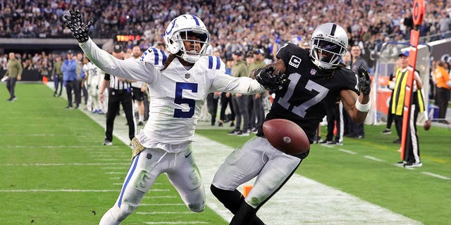 Cornerback Stephon Gilmore (5) of the Indianapolis Colts breaks up a pass intended for wide receiver Davante Adams (17) of the Las Vegas Raiders in the end zone late in the fourth quarter of a game at Allegiant Stadium Nov. 13, 2022, in Las Vegas.