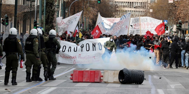 Riot police operated against demonstrators during clashes in Athens, Greece, on Sunday. Thousands of protesters take part in rallies around the country for fifth day over the conditions that led the deaths of dozens of people last week in Greece's worst recorded rail accident.