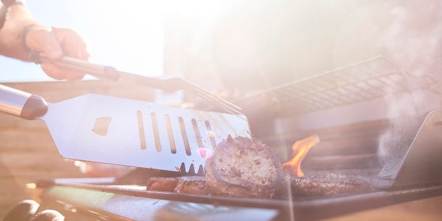 stock image of flipping hamburgers