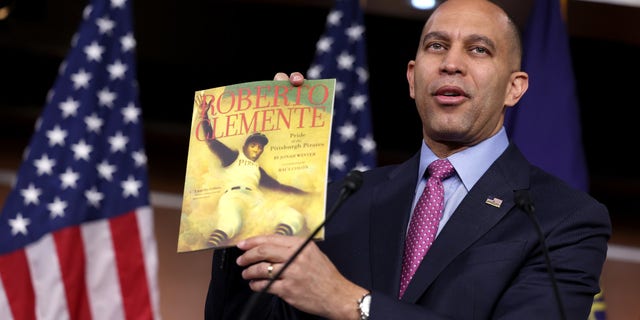 U.S. House Democratic Leader Hakeem Jeffries (D-NY) holds a copy of "Roberto Clemente" by Jonah Winter which was recently banned in public schools in Florida's Duval County, during a press conference at the U.S. Capitol on March 24, 2023, in Washington, DC. Jeffries spoke out against the recently passed Parents Bill of Rights Act and the banning and censorship of books in schools.