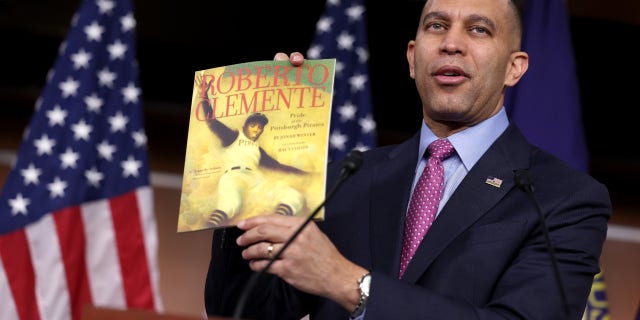 U.S. House Democratic Leader Hakeem Jeffries (D-NY) holds a copy of "Roberto Clemente" by Jonah Winter which was recently banned in public schools in Florida's Duval County, during a press conference at the U.S. Capitol on March 24, 2023 in Washington, DC. Jeffries spoke out against the recently passed Parents Bill of Rights Act and the banning and censorship of books in schools.