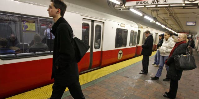 MBTA riders board a train at Harvard Square, Monday, January 28, 2008.