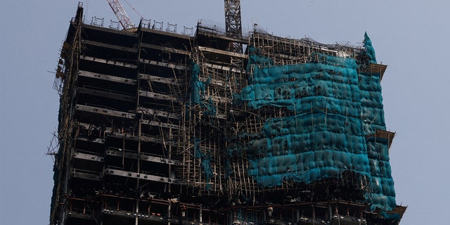 A skyscraper under construction is seen after a fire was put out in Tsim Sha Tsui in Hong Kong on March 3, 2023.
