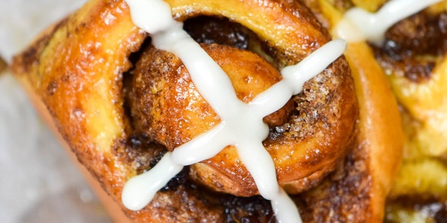 Finish the hot cross bun cinnamon rolls with an icing cross along the top of your baked treat.